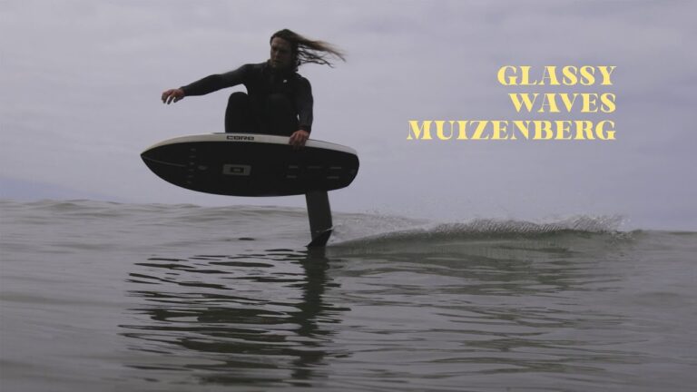 Glassy surf foiling waves in Muizenberg, South Africa